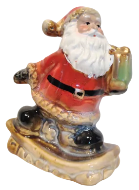 Ceramic Santa Figurine On Snowboard or Skis