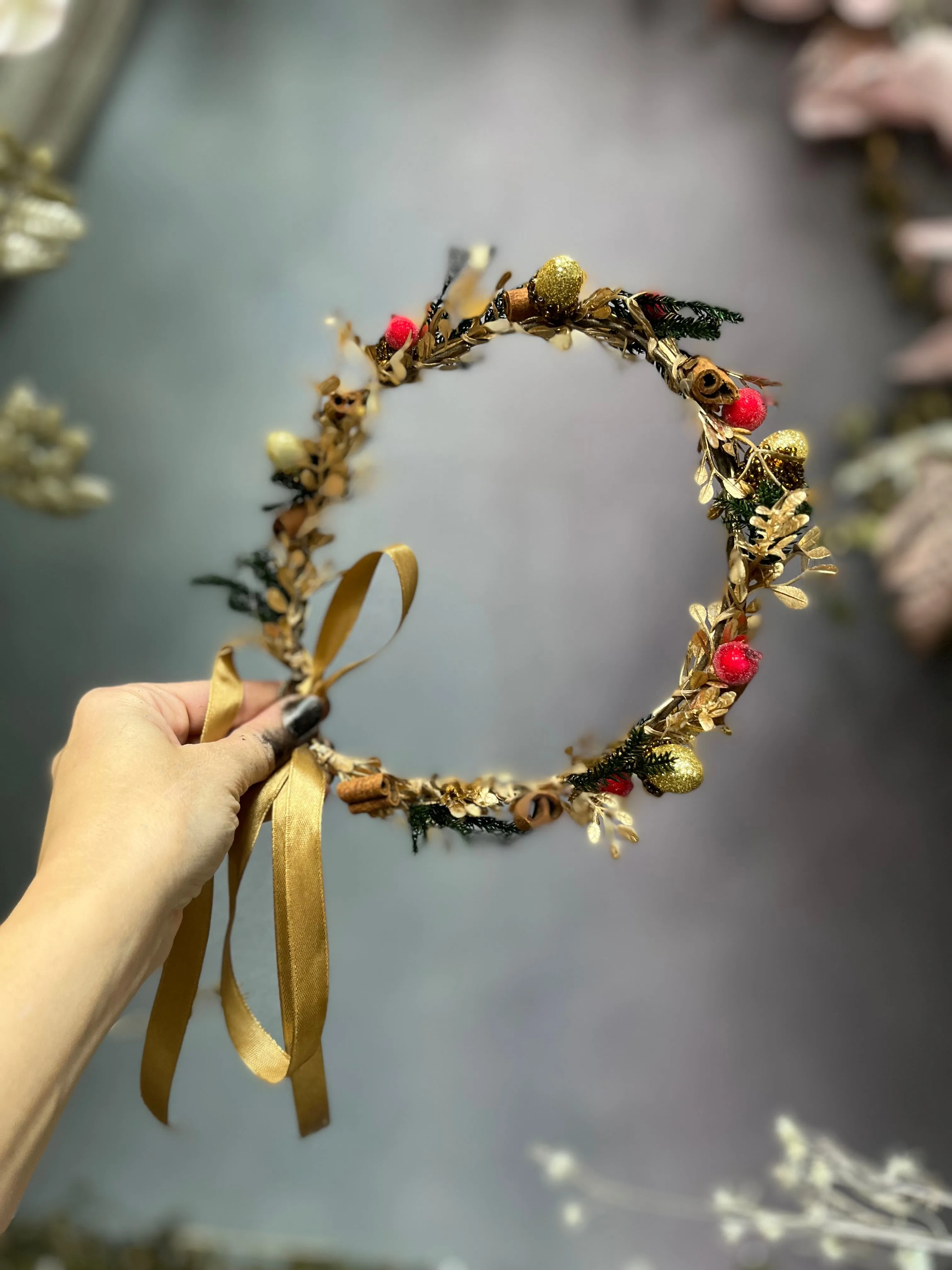 Golden Christmas flower wreath with cinnamon