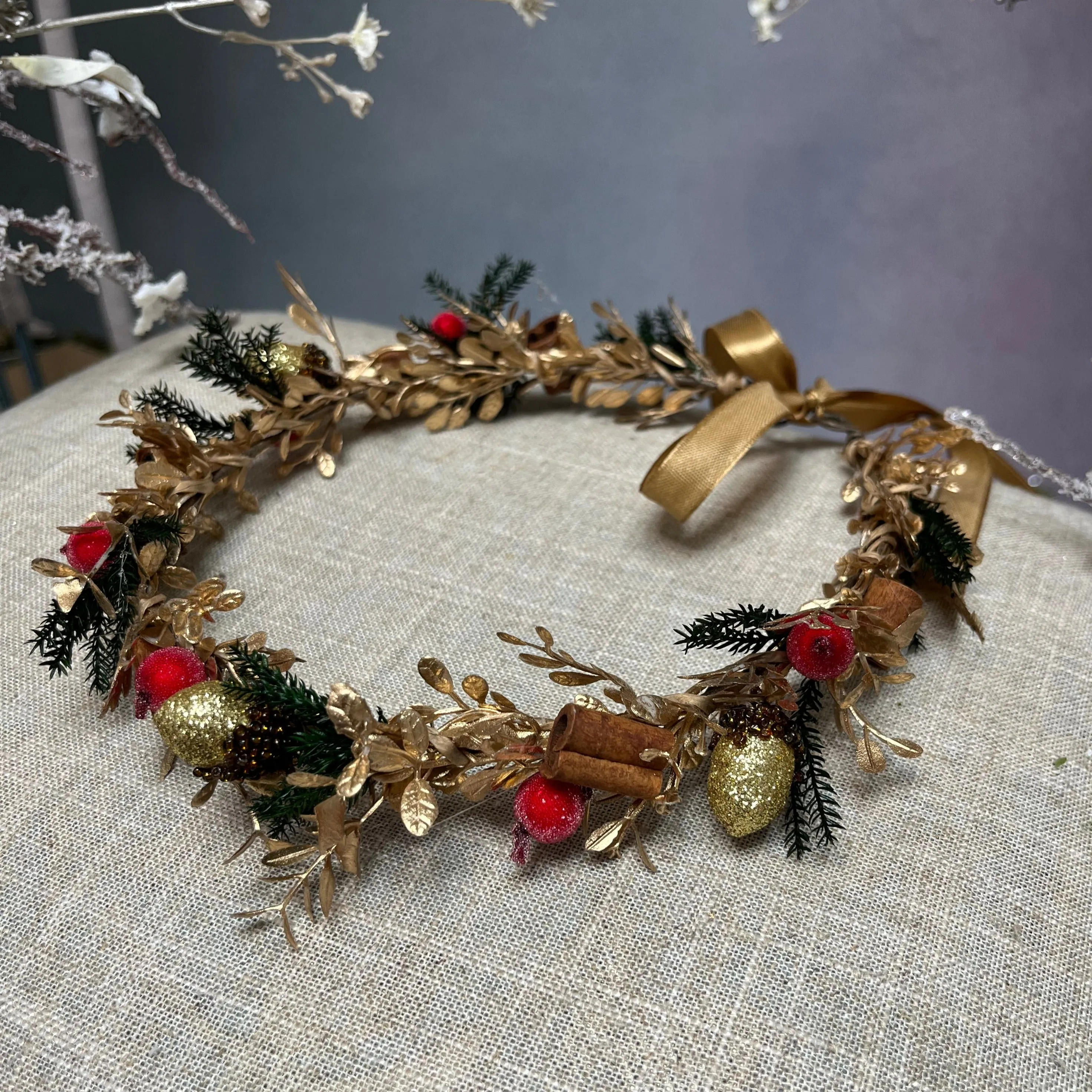 Golden Christmas flower wreath with cinnamon